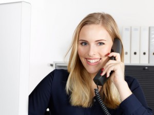 Female office assistant has a call at the office